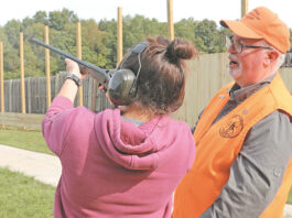 A volunteer hunter safety education instructor provides direction
